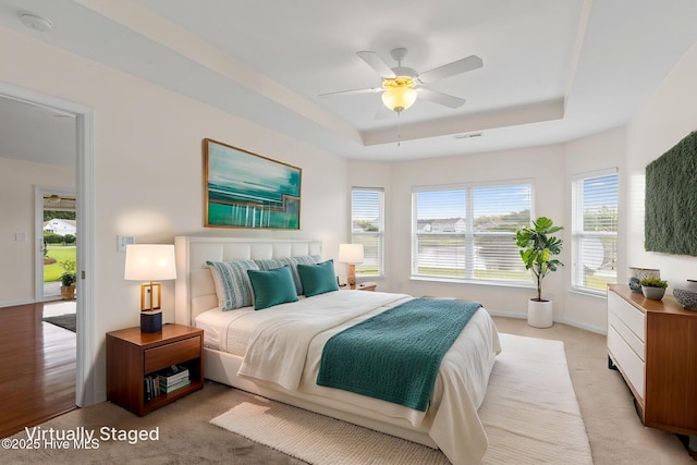770 Heather Glen Ln, Calabash, NC 28467 - bedroom featuring a raised ceiling, light colored carpet, baseboards, and a ceiling fan