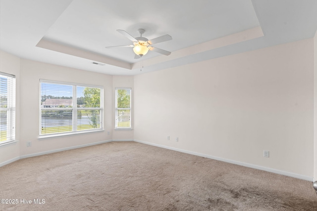 770 Heather Glen Ln, Calabash, NC 28467 - carpeted empty room with a tray ceiling, plenty of natural light, ceiling fan, and baseboards