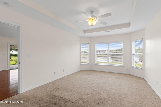 770 Heather Glen Ln, Calabash, NC 28467 - carpeted empty room featuring a raised ceiling, baseboards, a ceiling fan, and a smoke detector