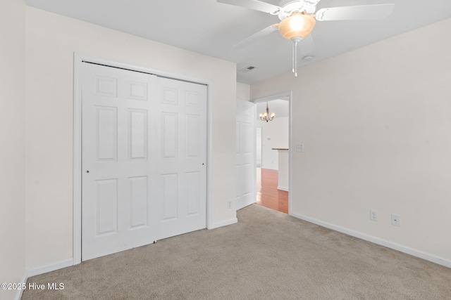 770 Heather Glen Ln, Calabash, NC 28467 - unfurnished bedroom featuring carpet, a closet, a chandelier, and baseboards