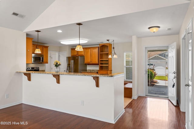 770 Heather Glen Ln, Calabash, NC 28467 - kitchen with stainless steel appliances, open shelves, a peninsula, a breakfast bar area, and recessed lighting