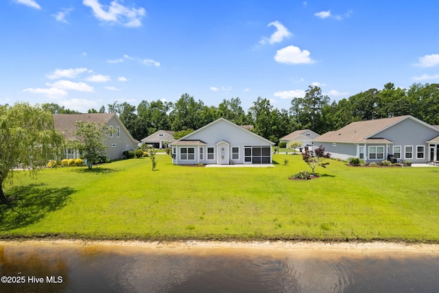770 Heather Glen Ln, Calabash, NC 28467 - back of property featuring a sunroom, a lawn, a water view, and view of wooded area