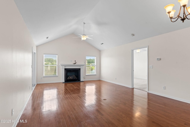 770 Heather Glen Ln, Calabash, NC 28467 - unfurnished living room featuring ceiling fan, a chandelier, wood finished floors, a fireplace with flush hearth, and high vaulted ceiling
