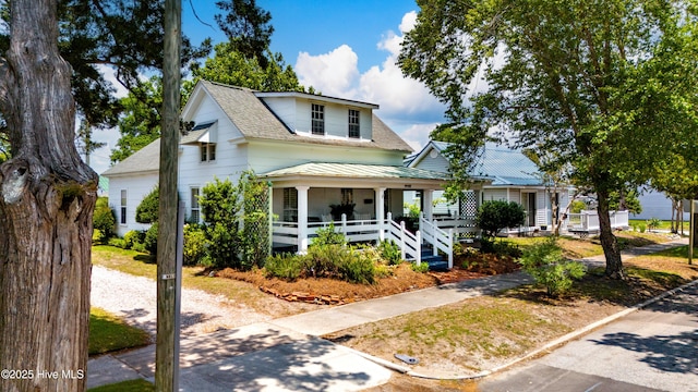 1402 Shepard St, Morehead City, NC 28557 - view of front of home featuring covered porch, a shingled roof, metal roof, and a standing seam roof