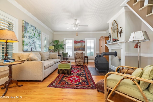 1402 Shepard St, Morehead City, NC 28557 - living area featuring crown molding, wood finished floors, a wood stove, and ceiling fan
