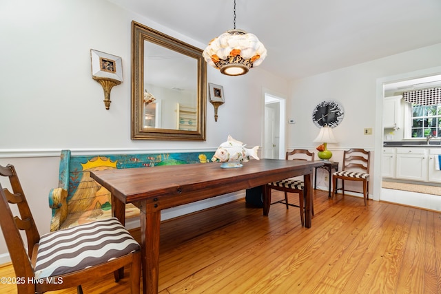 1402 Shepard St, Morehead City, NC 28557 - dining space with a wainscoted wall, light wood-style floors, and a chandelier