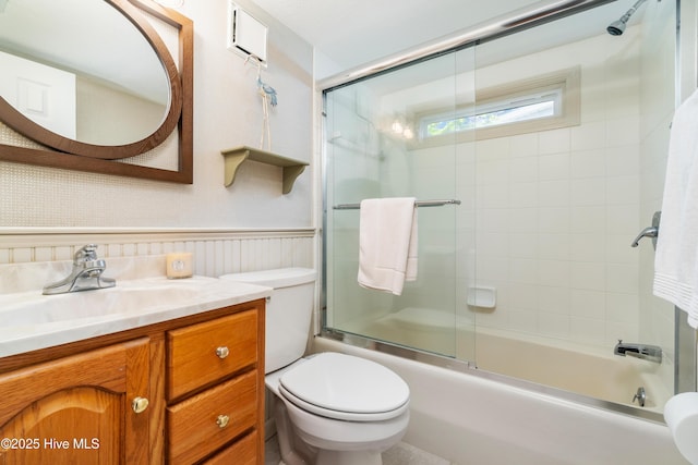 1402 Shepard St, Morehead City, NC 28557 - bathroom with toilet, vanity, shower / bath combination with glass door, wainscoting, and wallpapered walls