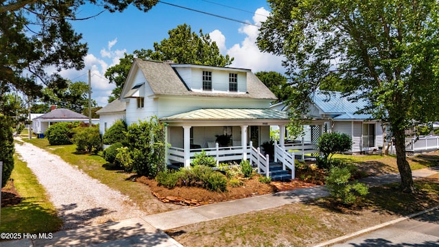 1402 Shepard St, Morehead City, NC 28557 - view of front facade featuring covered porch, a shingled roof, a standing seam roof, metal roof, and driveway
