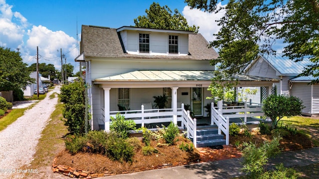 1402 Shepard St, Morehead City, NC 28557 - view of front of property featuring a standing seam roof, a porch, metal roof, a shingled roof, and gravel driveway