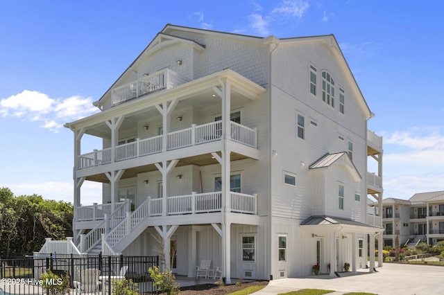 145 Oceanview Ln, North Topsail Beach, NC 28460 - view of front facade with a balcony and board and batten siding