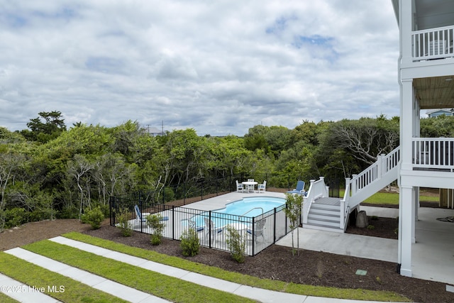 145 Oceanview Ln, North Topsail Beach, NC 28460 - view of swimming pool featuring stairway, a patio, and a view of trees