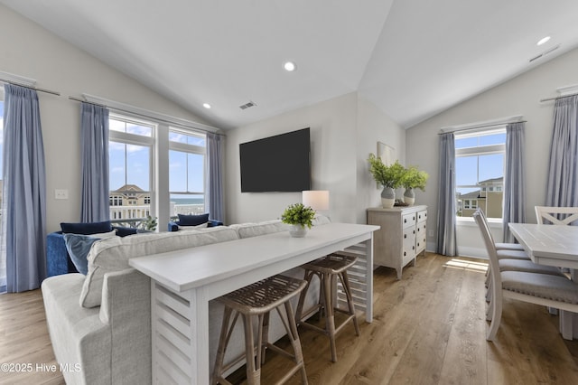 145 Oceanview Ln, North Topsail Beach, NC 28460 - kitchen featuring vaulted ceiling, healthy amount of natural light, light wood-style floors, a breakfast bar area, and recessed lighting