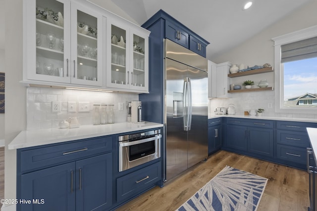 145 Oceanview Ln, North Topsail Beach, NC 28460 - kitchen with stainless steel appliances, blue cabinetry, light countertops, decorative backsplash, and recessed lighting