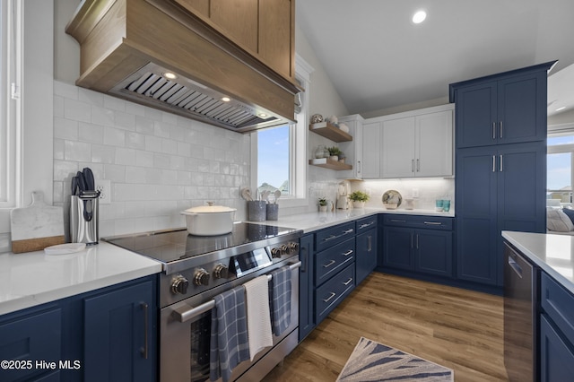 145 Oceanview Ln, North Topsail Beach, NC 28460 - kitchen with blue cabinetry, stainless steel stove, custom exhaust hood, light countertops, and recessed lighting