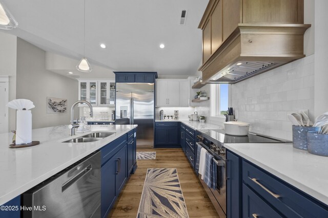 145 Oceanview Ln, North Topsail Beach, NC 28460 - kitchen with blue cabinetry, stainless steel appliances, a sink, tasteful backsplash, and recessed lighting