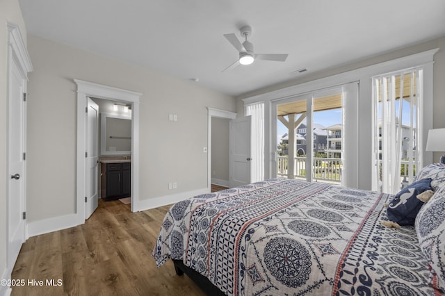 145 Oceanview Ln, North Topsail Beach, NC 28460 - bedroom featuring access to exterior, wood finished floors, baseboards, ensuite bathroom, and a ceiling fan