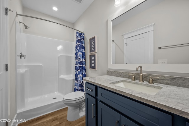 145 Oceanview Ln, North Topsail Beach, NC 28460 - full bath featuring wood finished floors, toilet, vanity, a shower with curtain, and recessed lighting