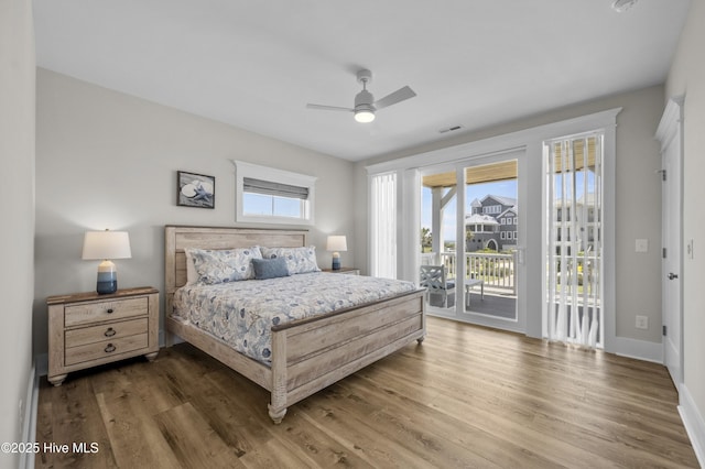 145 Oceanview Ln, North Topsail Beach, NC 28460 - bedroom featuring access to exterior, wood finished floors, a ceiling fan, and baseboards