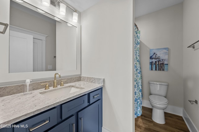 145 Oceanview Ln, North Topsail Beach, NC 28460 - bathroom featuring vanity, toilet, wood finished floors, baseboards, and a shower with curtain