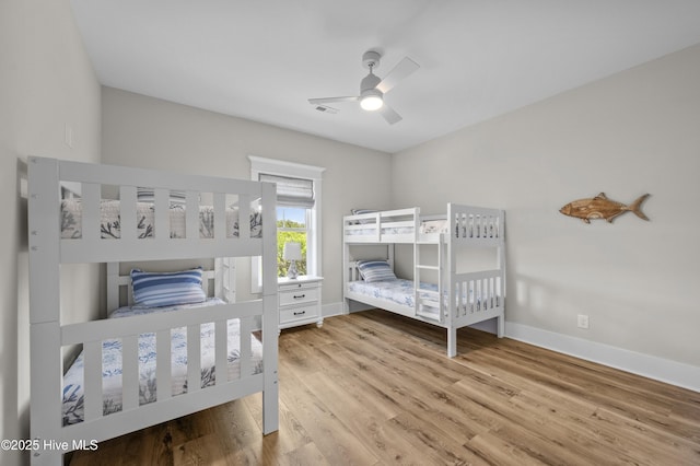 145 Oceanview Ln, North Topsail Beach, NC 28460 - bedroom with wood finished floors, baseboards, and a ceiling fan