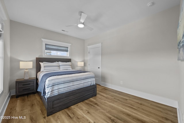 145 Oceanview Ln, North Topsail Beach, NC 28460 - bedroom with light wood-type flooring, baseboards, and ceiling fan
