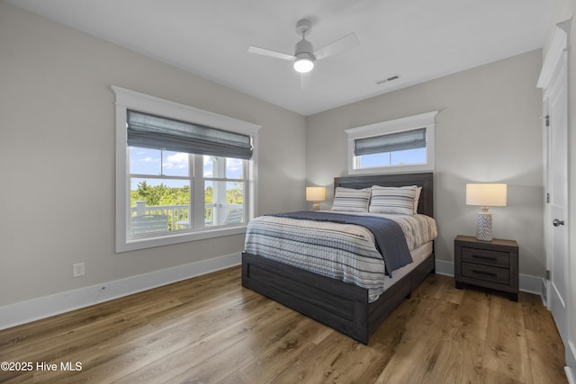 145 Oceanview Ln, North Topsail Beach, NC 28460 - bedroom with multiple windows, baseboards, and wood finished floors