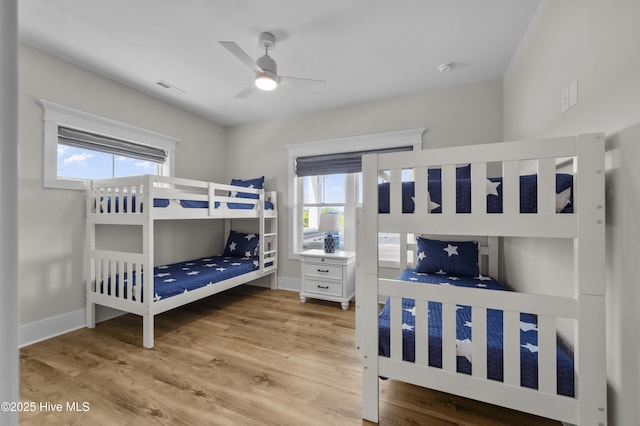 145 Oceanview Ln, North Topsail Beach, NC 28460 - bedroom with wood finished floors, baseboards, and a ceiling fan