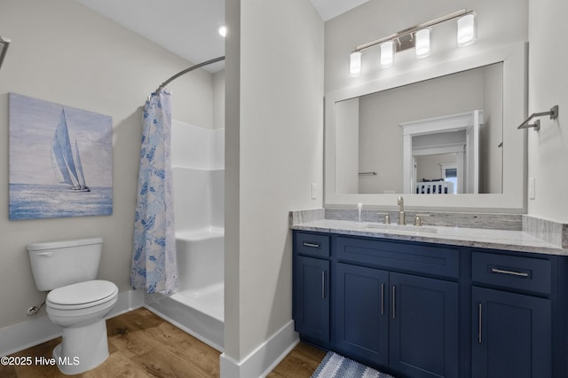 145 Oceanview Ln, North Topsail Beach, NC 28460 - bathroom with wood finished floors, vanity, toilet, and a shower with curtain