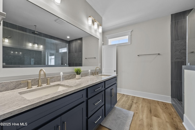 145 Oceanview Ln, North Topsail Beach, NC 28460 - full bath with double vanity, tiled shower, wood finished floors, and baseboards