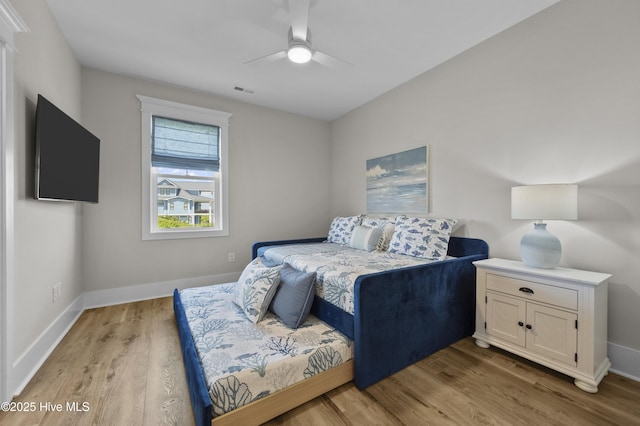 145 Oceanview Ln, North Topsail Beach, NC 28460 - bedroom with light wood-style flooring, baseboards, and ceiling fan