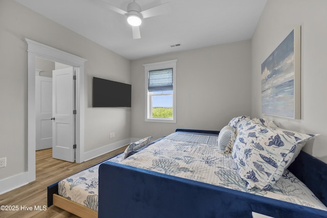 145 Oceanview Ln, North Topsail Beach, NC 28460 - bedroom featuring wood finished floors, baseboards, and a ceiling fan