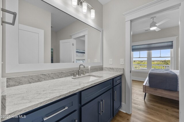 145 Oceanview Ln, North Topsail Beach, NC 28460 - ensuite bathroom with vanity, wood finished floors, ceiling fan, and baseboards
