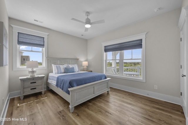 145 Oceanview Ln, North Topsail Beach, NC 28460 - bedroom featuring multiple windows, wood finished floors, and baseboards