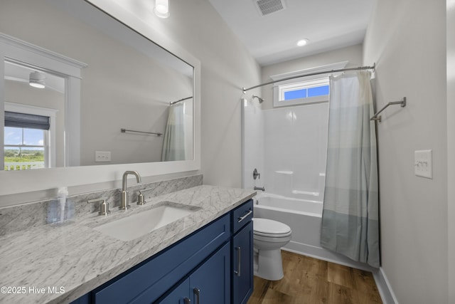 145 Oceanview Ln, North Topsail Beach, NC 28460 - bathroom with vanity, toilet, wood finished floors, shower / tub combo, and healthy amount of natural light