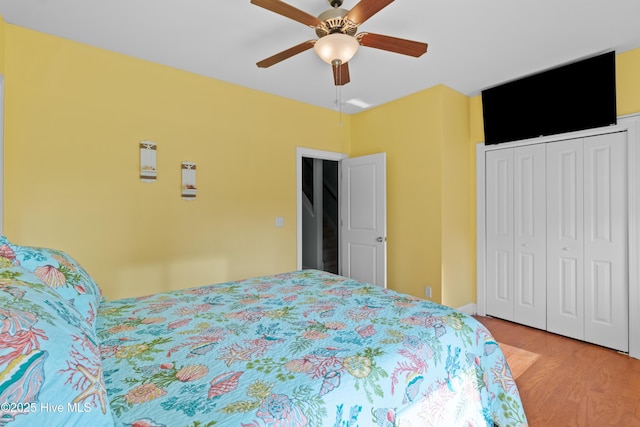 1102 Canal Dr Unit 1 & 2, Carolina Beach, NC 28428 - bedroom with wood finished floors, a closet, and a ceiling fan