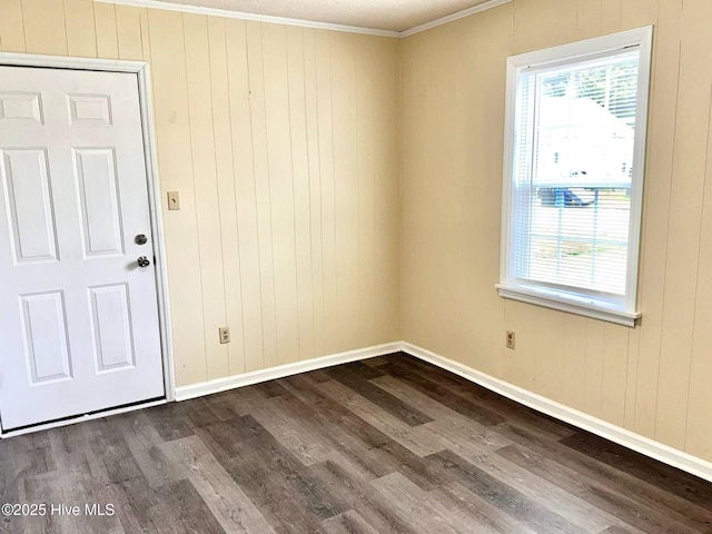 102 Nash St, Elm City, NC 27822 - spare room with crown molding, dark wood-style flooring, and plenty of natural light