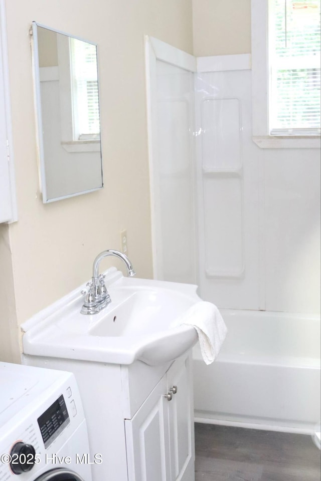 102 Nash St, Elm City, NC 27822 - full bath featuring washer / clothes dryer, vanity, healthy amount of natural light, and shower / washtub combination