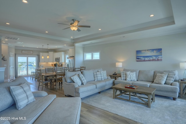 876-878 Villas Dr, North Topsail Beach, NC 28460 - living area with a raised ceiling, recessed lighting, plenty of natural light, light wood-style floors, and crown molding