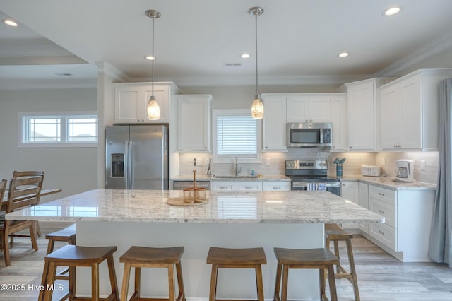 876-878 Villas Dr, North Topsail Beach, NC 28460 - kitchen with stainless steel appliances, crown molding, a kitchen breakfast bar, tasteful backsplash, and recessed lighting