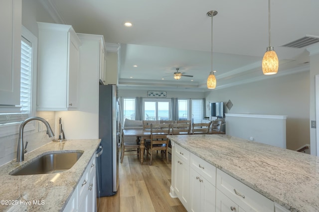 876-878 Villas Dr, North Topsail Beach, NC 28460 - kitchen featuring a sink, freestanding refrigerator, light wood finished floors, white cabinets, and a ceiling fan
