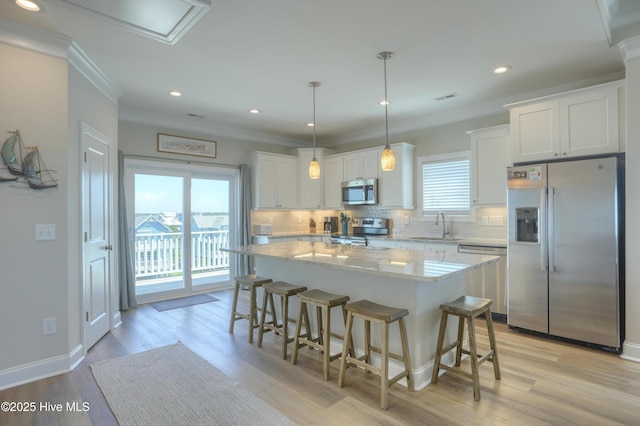 876-878 Villas Dr, North Topsail Beach, NC 28460 - kitchen with appliances with stainless steel finishes, a sink, a breakfast bar, decorative backsplash, and white cabinets