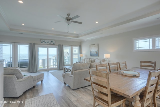 876-878 Villas Dr, North Topsail Beach, NC 28460 - dining space featuring a tray ceiling, light wood-style floors, ornamental molding, a ceiling fan, and recessed lighting