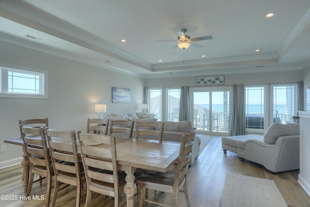 876-878 Villas Dr, North Topsail Beach, NC 28460 - dining area featuring a raised ceiling, light wood-style flooring, a ceiling fan, crown molding, and recessed lighting