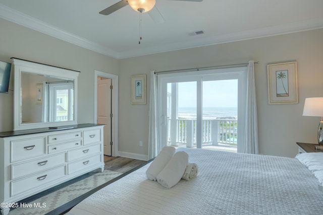 876-878 Villas Dr, North Topsail Beach, NC 28460 - bedroom with ornamental molding, access to exterior, multiple windows, a water view, and wood finished floors