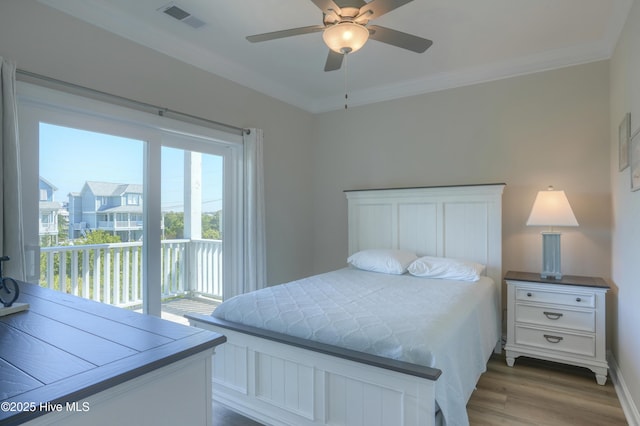 876-878 Villas Dr, North Topsail Beach, NC 28460 - bedroom with access to exterior, dark wood finished floors, crown molding, ceiling fan, and baseboards