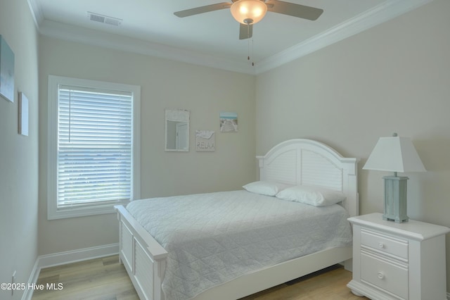 876-878 Villas Dr, North Topsail Beach, NC 28460 - bedroom with crown molding, light wood-style flooring, baseboards, and a ceiling fan