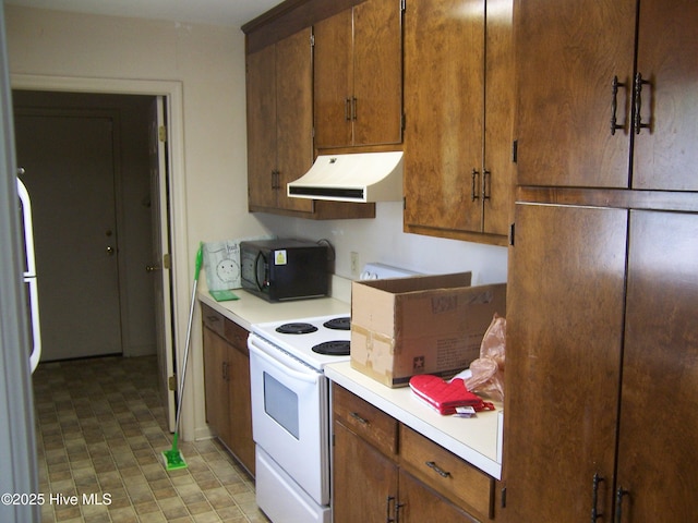 100 Pinehurst Trace Dr, Pinehurst, NC 28374 - kitchen featuring exhaust hood, black microwave, light countertops, and brown cabinetry