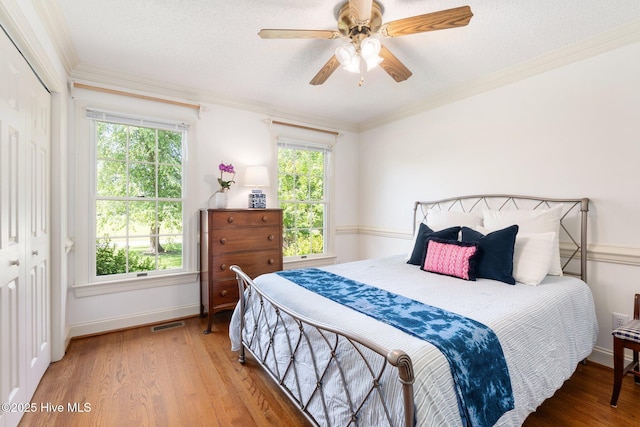 116 Spencer Ln, Newport, NC 28570 - bedroom with wood finished floors, crown molding, ceiling fan, and a closet