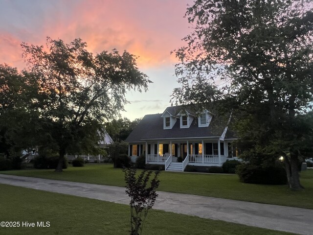 116 Spencer Ln, Newport, NC 28570 - new england style home featuring covered porch, a front lawn, and driveway