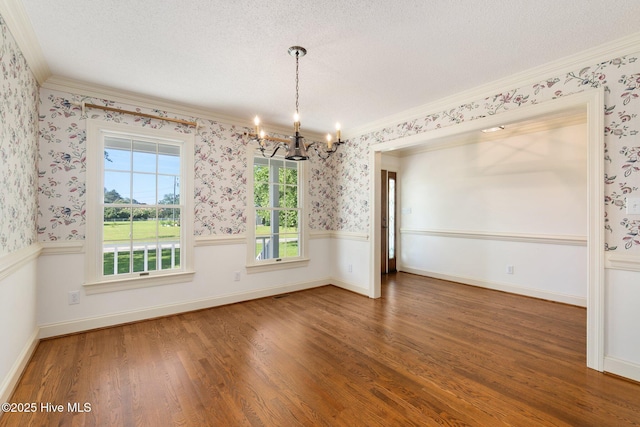 116 Spencer Ln, Newport, NC 28570 - unfurnished dining area featuring a chandelier, ornamental molding, wood finished floors, a textured ceiling, and wallpapered walls